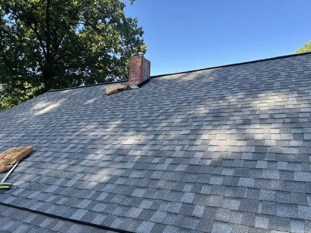 Clean roof lines up to the chimney after a repair