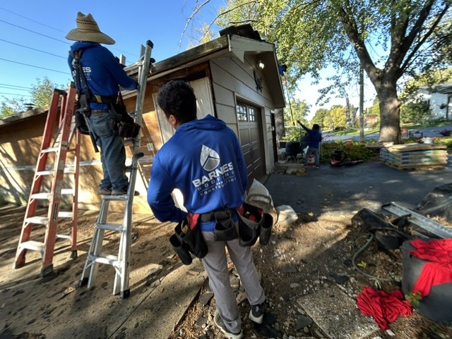 Barnes crew working from ladders during a tear-off